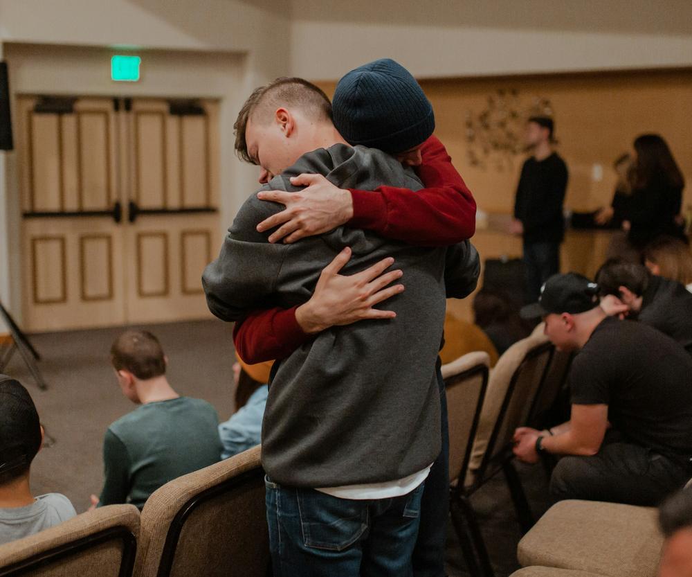 Two men in a long embrace